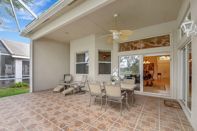 view of terrace featuring ceiling fan and glass enclosure