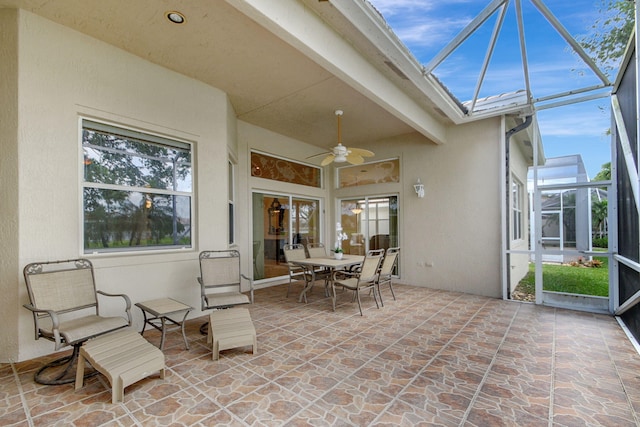 exterior space with ceiling fan and beamed ceiling