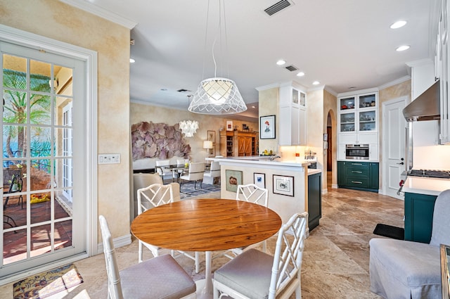 tiled dining room featuring ornamental molding