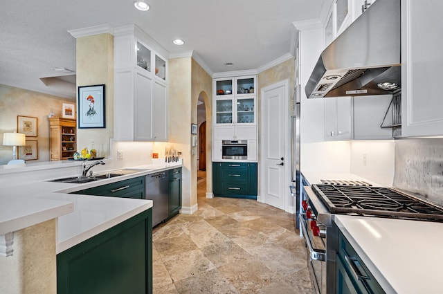 kitchen featuring backsplash, wall chimney range hood, white cabinetry, and stainless steel appliances