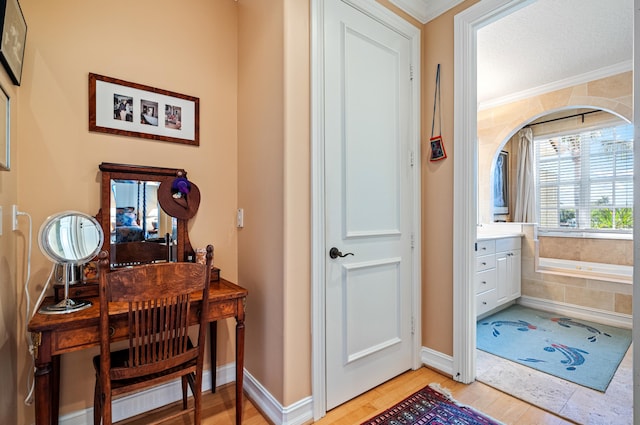 interior space with ornamental molding and light wood-type flooring