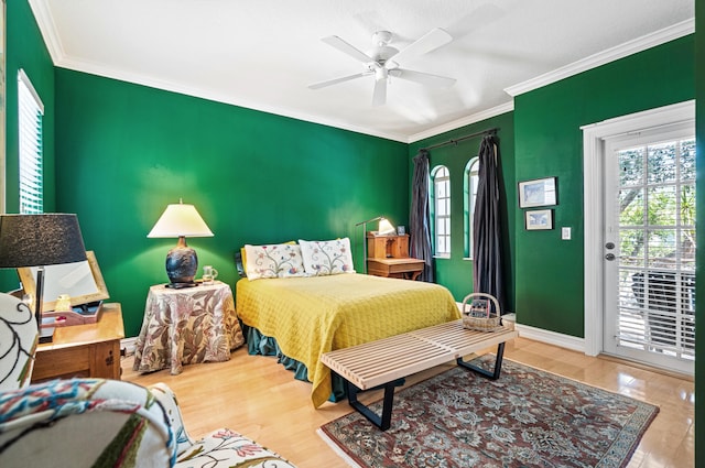 bedroom with crown molding, light hardwood / wood-style floors, ceiling fan, and access to exterior