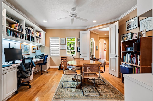 office space featuring ornamental molding, light hardwood / wood-style flooring, ceiling fan, and a textured ceiling