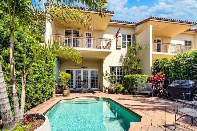 back of house with a patio area, french doors, ceiling fan, and a balcony