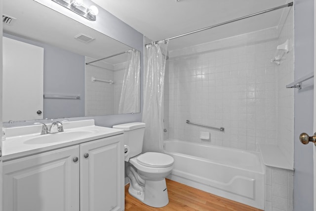 full bathroom featuring shower / tub combo with curtain, hardwood / wood-style floors, toilet, and vanity with extensive cabinet space