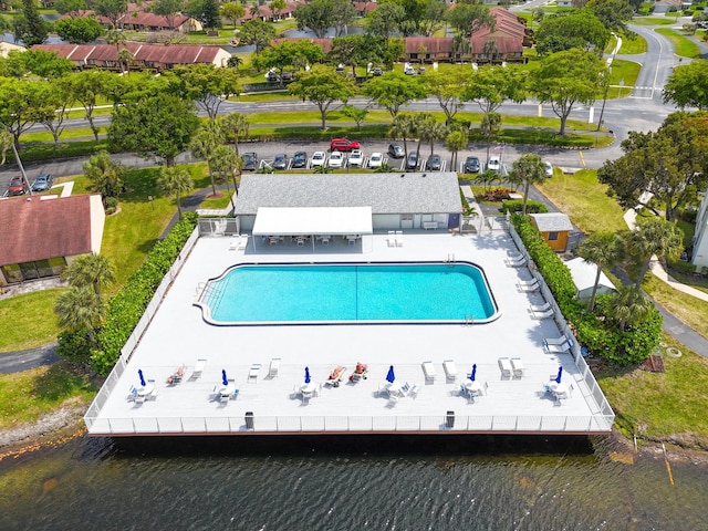 view of pool with a patio and a water view