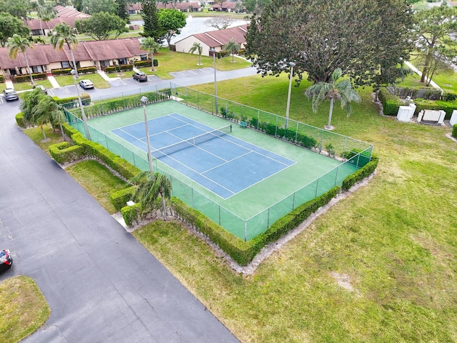 view of sport court featuring a yard