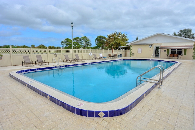 view of swimming pool with a patio