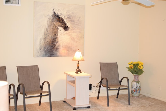 sitting room featuring ceiling fan