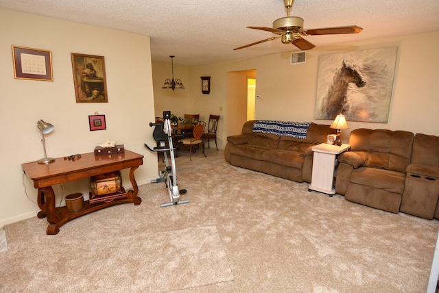 carpeted living room with ceiling fan and a textured ceiling