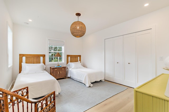 bedroom featuring a closet and light wood-type flooring