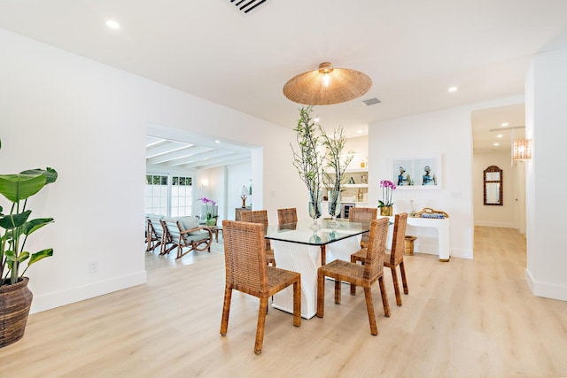 dining room with a chandelier and light wood-type flooring