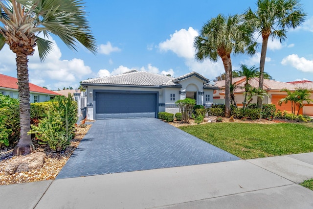 view of front of property with a garage and a front lawn