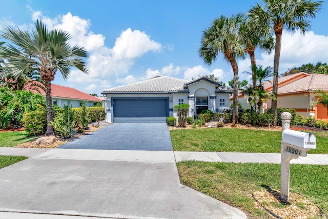 view of front of home featuring a garage and a front yard