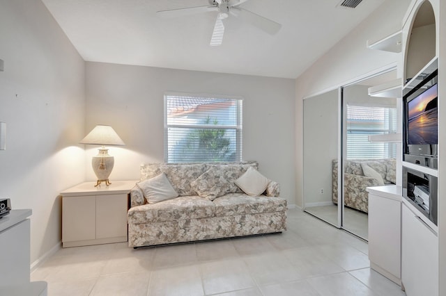 living room featuring ceiling fan, plenty of natural light, and lofted ceiling