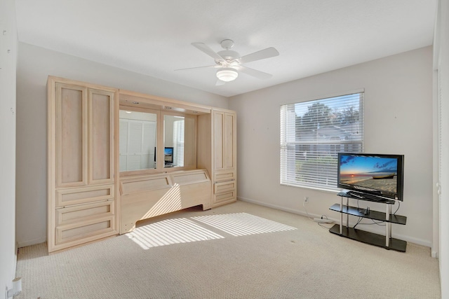 unfurnished bedroom featuring ceiling fan and light carpet