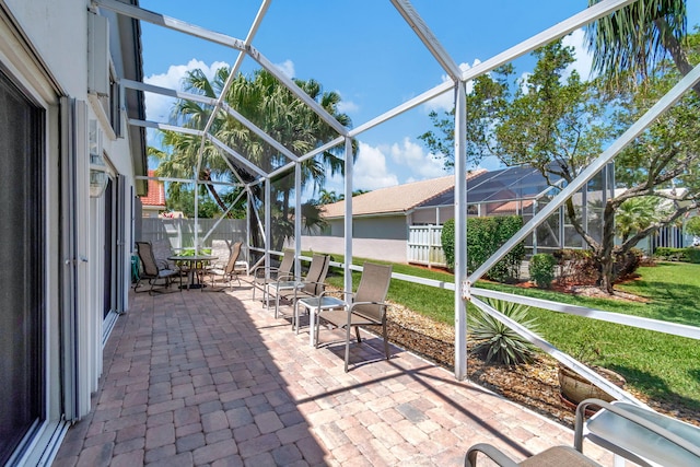 view of patio with glass enclosure