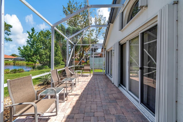 unfurnished sunroom featuring a water view