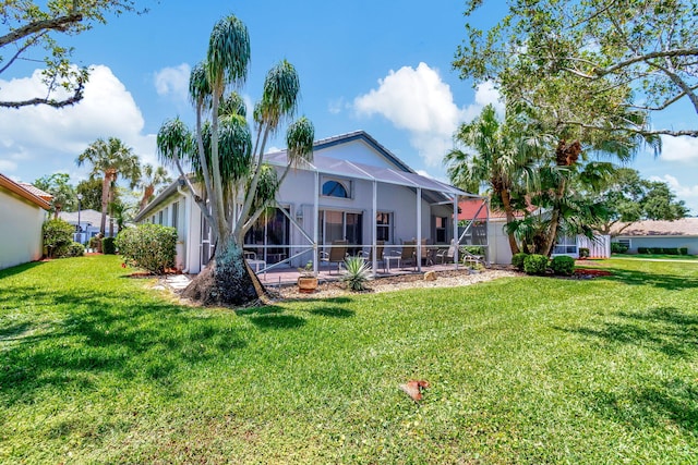 back of property with a lanai and a yard