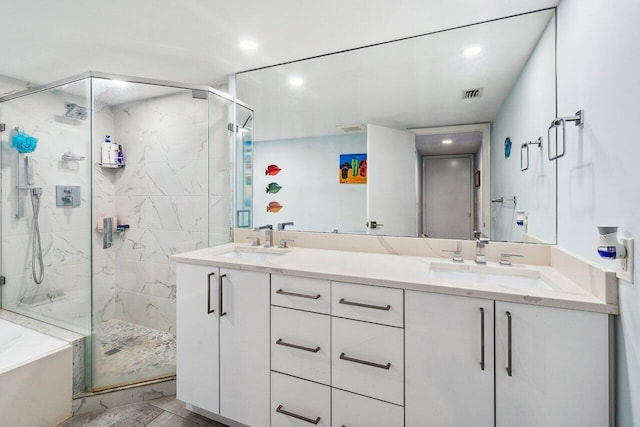 bathroom featuring tile flooring, independent shower and bath, and dual bowl vanity