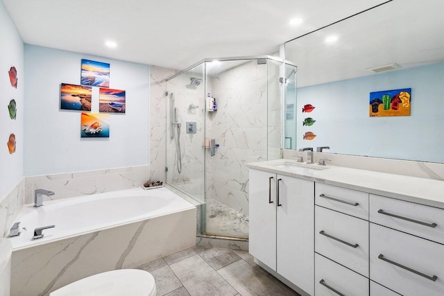 full bathroom featuring tile flooring, vanity with extensive cabinet space, separate shower and tub, and toilet