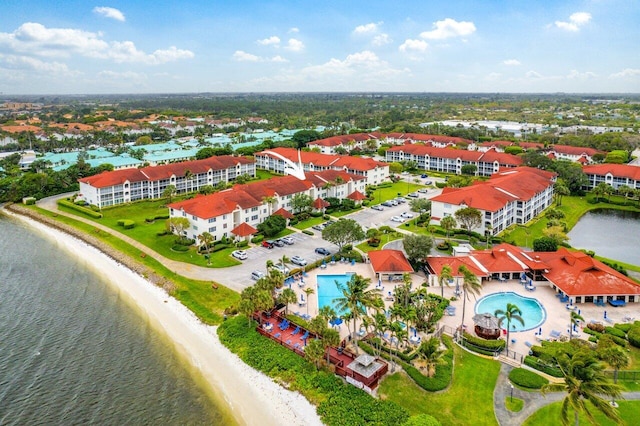 birds eye view of property with a beach view and a water view