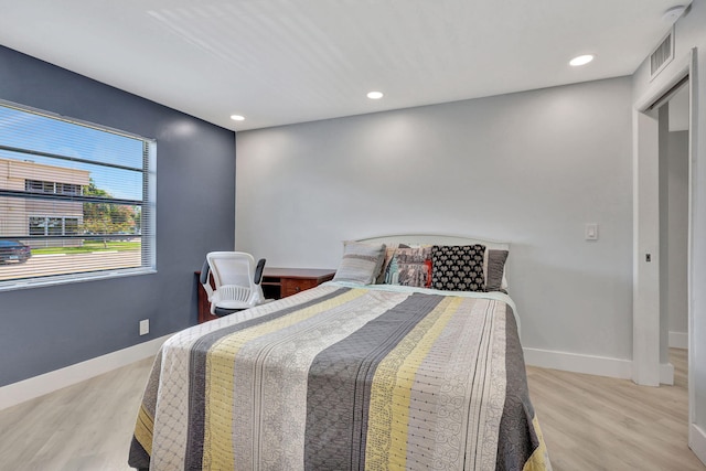 bedroom with recessed lighting, visible vents, light wood-style flooring, and baseboards