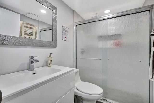 bathroom with toilet, a stall shower, recessed lighting, and vanity