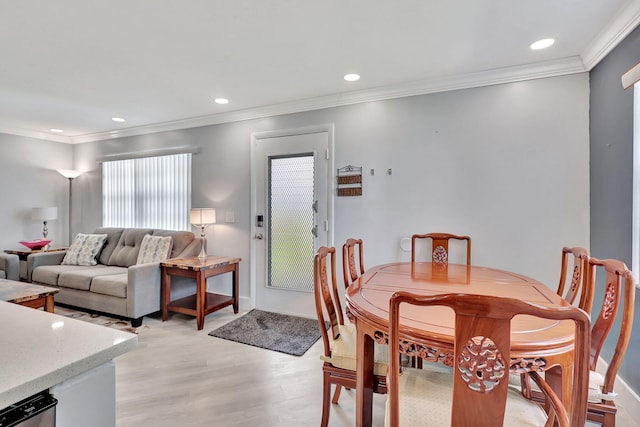 dining area featuring ornamental molding, light wood finished floors, baseboards, and recessed lighting