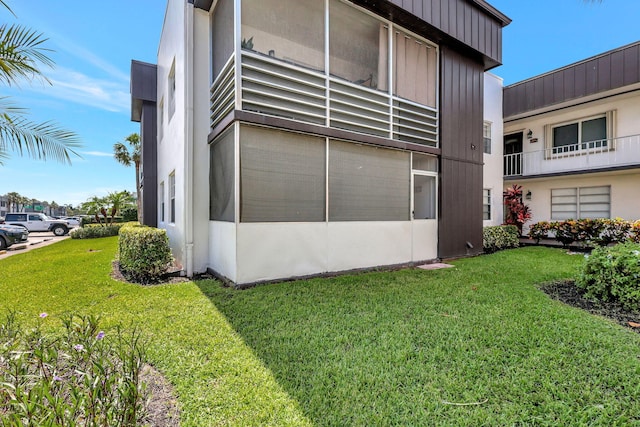 view of side of home featuring a yard