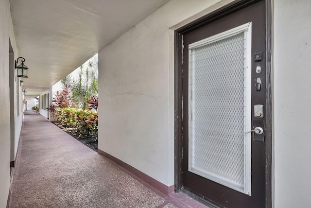 property entrance with stucco siding