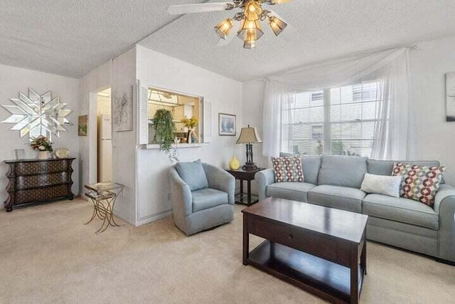 carpeted living room with ceiling fan and a textured ceiling