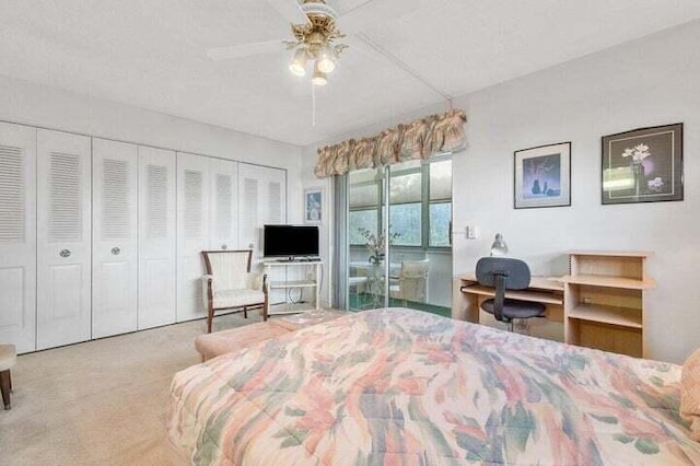 bedroom featuring light colored carpet, ceiling fan, and a closet