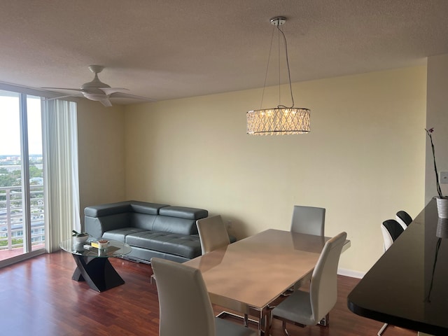 dining room featuring a textured ceiling, ceiling fan, expansive windows, and dark wood-type flooring