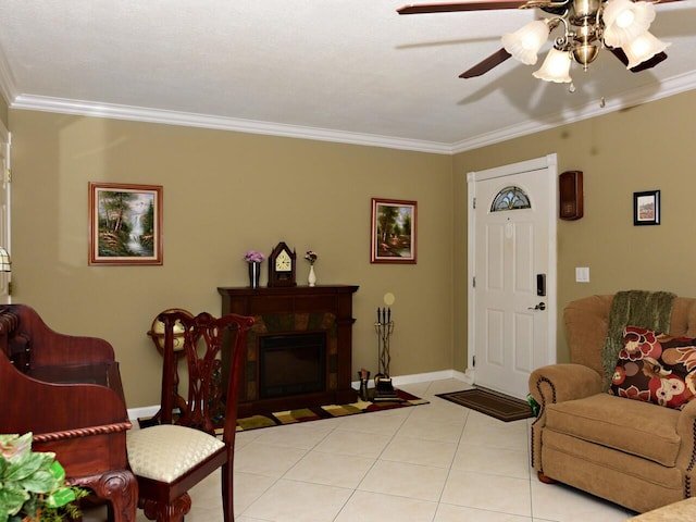 living room with crown molding, ceiling fan, and light tile flooring