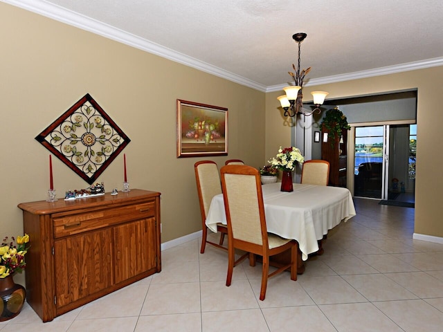 dining area featuring a chandelier, crown molding, and light tile flooring