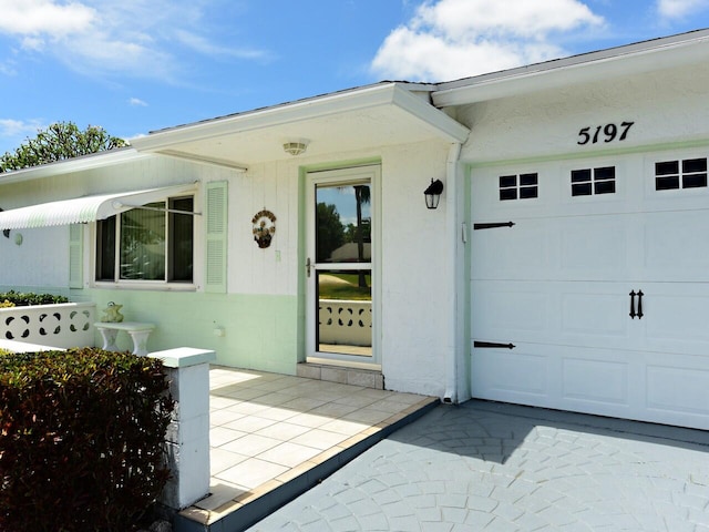 view of exterior entry with a garage