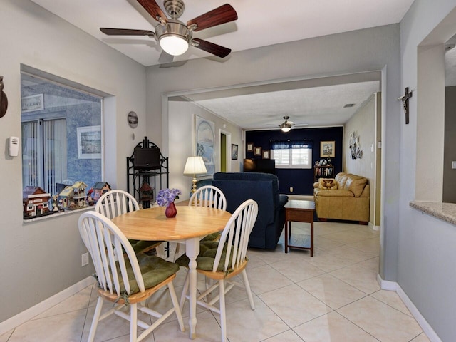 tiled dining area featuring ceiling fan