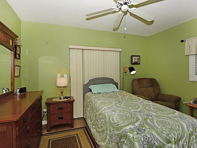 bedroom featuring ceiling fan and dark hardwood / wood-style floors