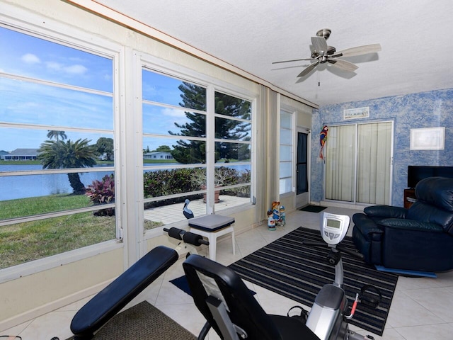 interior space featuring ceiling fan, a water view, and a wealth of natural light