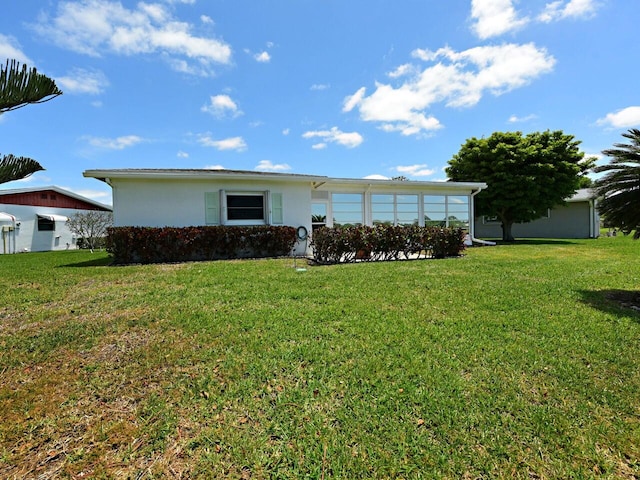 back of house with a lawn