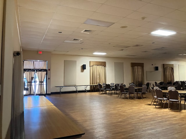 interior space featuring hardwood / wood-style flooring and a paneled ceiling