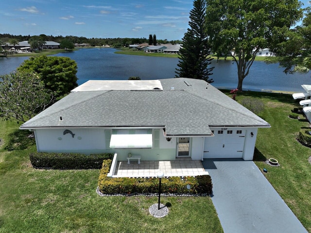 view of front of house featuring a water view, a garage, and a front yard