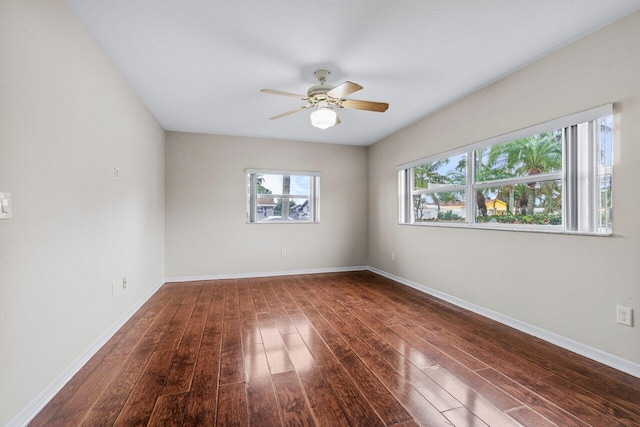 spare room featuring dark wood-type flooring and ceiling fan