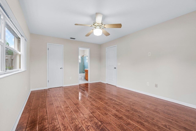 empty room featuring dark wood-type flooring and ceiling fan