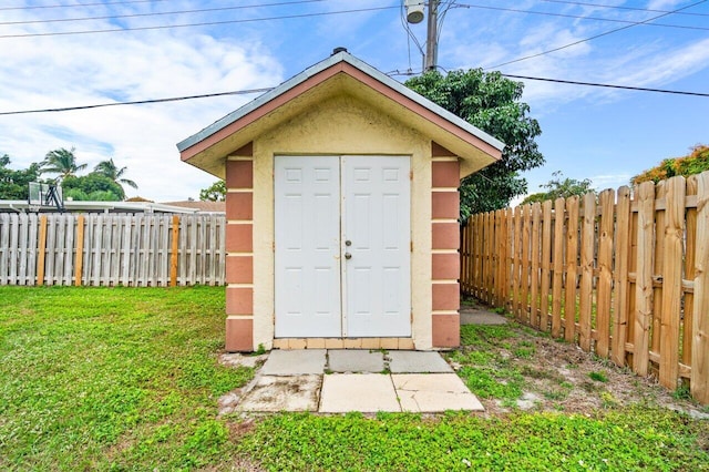 view of outdoor structure featuring a lawn