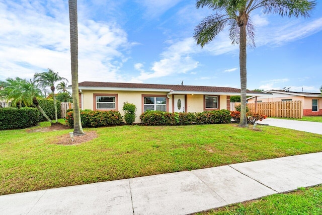 single story home featuring a front lawn