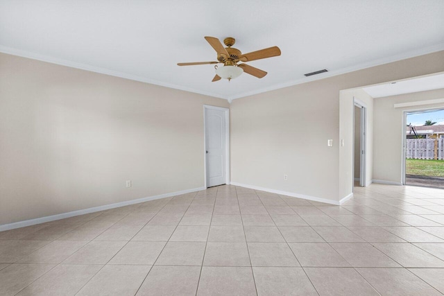 tiled spare room with ceiling fan and ornamental molding