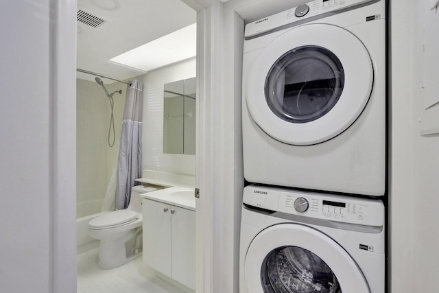 laundry room with stacked washer and clothes dryer