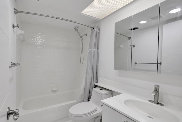 full bathroom with shower / bath combo with shower curtain, toilet, and vanity